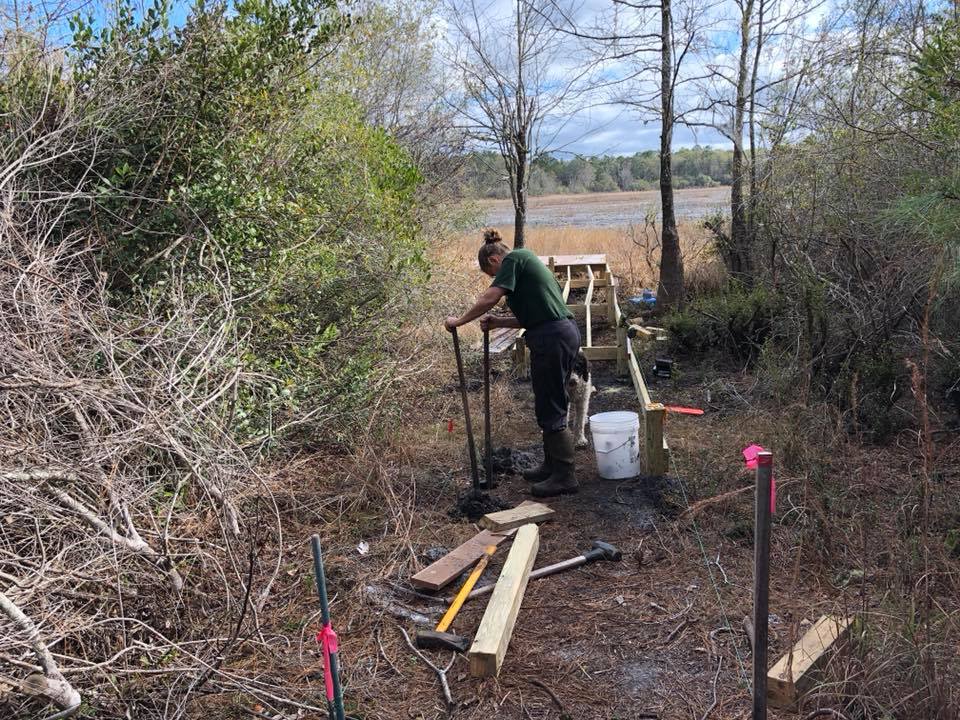 Donna digging corner post holes